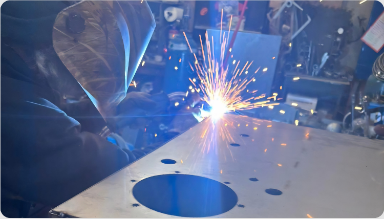 Welding sparks over a stainless steel panel